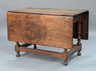 Draw/Bar Table having drop leaves, set on base with turned legs and box stretchers ending in round feet, New York circa 1750, (top replaced).
height 2