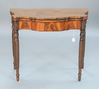 Sheraton Mahogany Games Table having shaped top with twist turned legs, (top with imperfection), circa 1830.
height 30 inches, width...