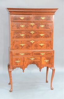 Queen Anne Highboy, walnut and burl walnut veneer in two parts, upper section with crown molding over two over three drawers on base...