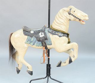 Diminutive Carousel Horse in old paint, collar mounted with jeweled glass.
height 38 inches, length 46 inches.
Provenance: From the ...