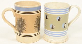 Two Mocha Mugs, to include one with trees and banding, height 5 1/4 inches, the other with cats eyes and banding, height 5 inches (c...