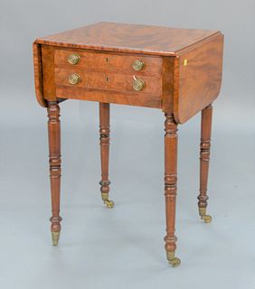 Sheraton Mahogany Work Table having drop leaves over two drawers and bag drawer (bag missing) all set on turned legs, circa 1820.
he...