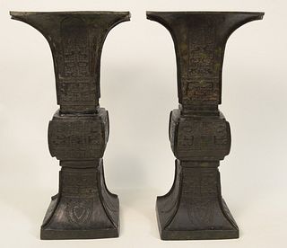 Pair of Chinese Bronze Beaker Vases, square form with flared rim and archaic relief decoration. 
height 19 inches, top diameter 9 1/...