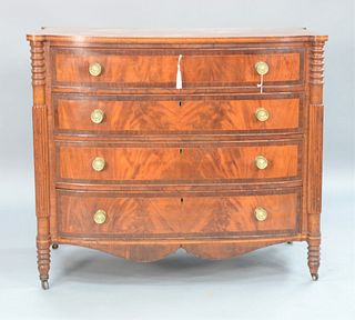 Sheraton Mahogany Bowed Front Chest with turret corners and four drawers flanked by reeded columns and turned legs, drawers having f...