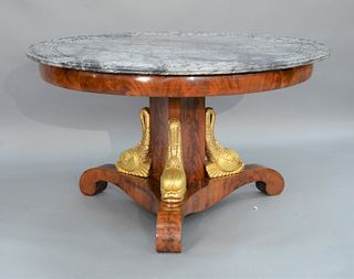 Empire Round Table having grey mottled marble top with grooved circular lines on mahogany base wit hthree gilt dolphins on plain base.
height 29 inche