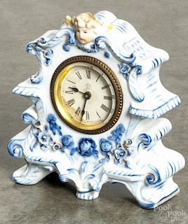 Ansonia, porcelain shelf clock with a cherub crest, 6'' h.