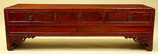 Antique Chinese red polychromed carved wood low bench cabinet.