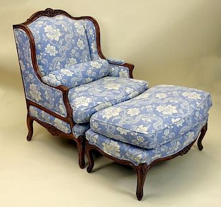 Nicely Carved Walnut upholstered bergere with ottoman and bolster.