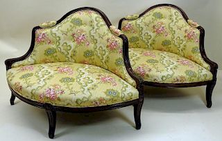 Pair of carved wood upholstered love seats. Ovoid Shape.