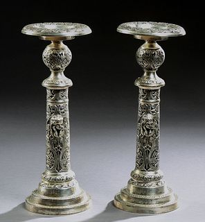 Pair of Large Silverplated Spelter Pricket Candlesticks, 20th c., the candle cup on a relief ball socle, atop a cylindrical support...