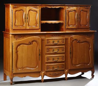 French Carved Cherry Buffet a Deux Corps, 20th c., the rounded edge serpentine top with central open storage flanked by double cupbo...