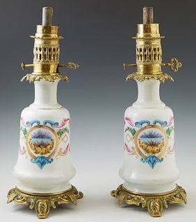 Pair of Old Paris Style Gilt Ormolu Mounted Porcelain Oil Lamps, 19th c., of baluster bottle form, with hand painted reserves of flo...