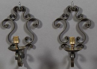 Pair of French Medieval Style Single Light Sconces, 20th c., the scrolled back plate issuing a scrolled arm with a candle cup, surfa...