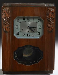 French Art Deco Carved Walnut Westminster Chiming Mantel Clock, c. 1930, by Jura, the octagonal steel face flanked by grape and leaf...