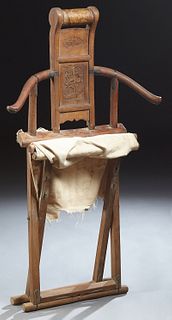 Chinese Ming Dynasty Carved Elm Folding Chair, 17th c., with a rolling head rest, above a dragon carved back flocked by curvilinear...