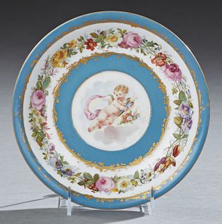 French Sevres Porcelain Cabinet Bowl, c.1840, with a central hand painted reserve of cupid, within gilt decorated heavenly blue bord...