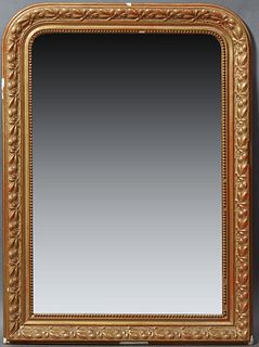French Louis Philippe Style Gilt and Gesso Overmantle Mirror, 19th c., the arched frame with relief leaf and berry decoration, aroun...