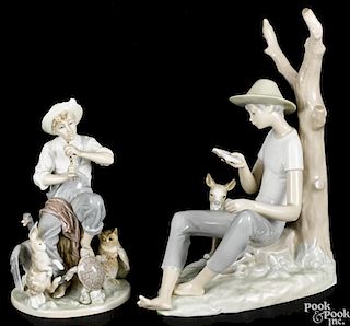 Two Lladro porcelain figures, to include a boy reading, 12'' h., and a boy playing a flute, 8 1/4'' h.