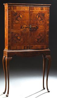 Queen Anne Marquetry Inlaid Walnut Cabinet on Stand, 18th c., the ogee crown over double doors intricately inlaid with parrots and f...