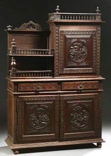 French Provincial Henri II Style Carved Oak Buffet a Deux Corps, c. 1880, Brittany, the spindled crown over a figural carved cupboar...