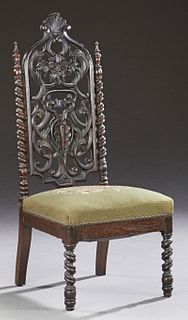 English Carved Mahogany Gothic Slipper Chair, 19th c., the arched pierced floral crest over a pierced foliate splat flanked by doubl...