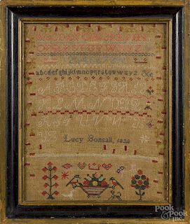 English wool on linen sampler, dated 1828, wrought by Lucy Bonsall, 14'' x 11''.