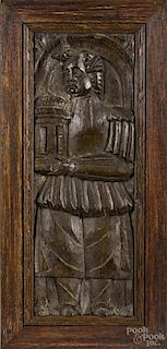 English carved oak panel depicting Saint Barbara holding her tower, 17th c., 22 1/2'' x 10 3/4''.