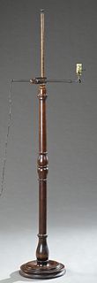 Late Victorian Tuned Mahogany Floor Lamp, late 19th c., the turned tapered support with an adjustable arm, on a stepped turned circu...