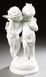 Large Parian Figure, c. 1900, of Cupid's Kiss, on a stepped circular leaf relief base with a bird's nest, H.- 24 in., Dia.- 11 1/2 i...