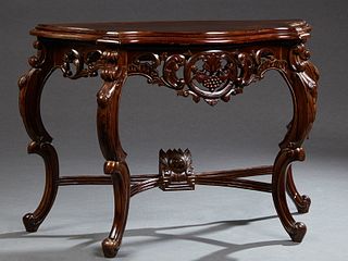 Continental Style Carved Walnut Serpentine Front Console Table, 20th c., the ogee edge shaped top over a pierced and carved wide ski...