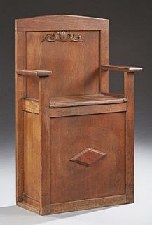 Diminutive English Carved Oak Hall Seat, 20th c., the arched back over a lifting seat to storage flanked by cutout trapezoidal arms,...