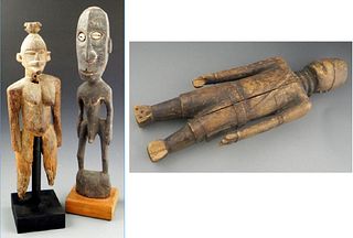 Group of Three African Carved Wooden Figures, early 20th c., consisting of a man with cowrie shell eyes, a woman on a stand, and a m...