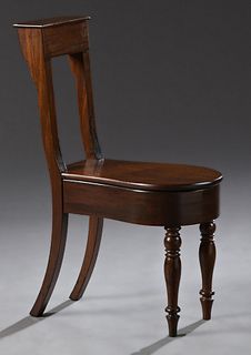 French Carved Mahogany Bidet, 19th c., the back with a lift top compartment over a curved lid lifting to a porcelain liner on ring t...