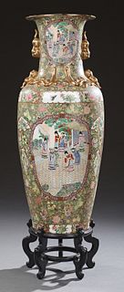 Large Oriental Famille Rose Baluster Palace Vase, 20th c., the sides with gilt Foo dog handles above panel decorations of figures ov...