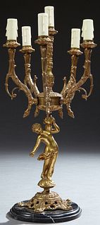 French Style Six Light Figural Candelabra, 20th c., the arms upheld by a putto, on a pierced brass base mounted on a stepped figured...