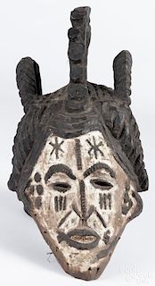 Nigerian Igbo (Ibo) carved and polychrome painted helmet mask, agbogho mmwo, 21'' h.