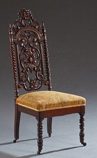 American Rococo Revival Carved Walnut Slipper Chair, c. 1875, with a pierced floral crest over a pierced scrolled back within rope t...