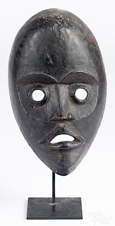 African carved mask by the Dan tribe of the Ivory Coast and Liberia, 10'' h.