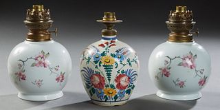 Group of Three French Bottle Form Baluster Oil Lamps, 20th c., two Limoges, one Provincial, all with floral decoration and wired for...