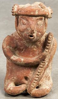 Pre-Columbian seated ceramic figure with a red slip finish, 8 1/4'' h. Provenance: DeHoogh Gallery