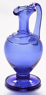 Blown molded cobalt blue glass pitcher, 19th c., with applied threading, a handle, and a tooled rim
