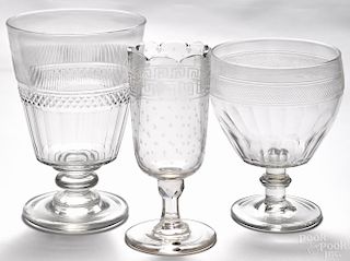 Three molded and cut colorless glass footed vases, 19th c., to include one etched example, 8 1/2'' h.