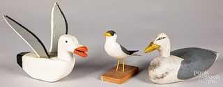 Three carved and painted shorebirds.
