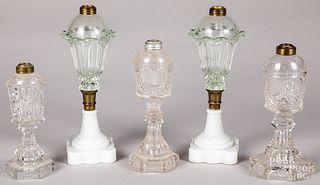 Five colorless and clambroth glass fluid lamps.