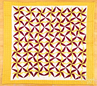 Yellow and burgundy sawblade quilt, ca. 1910