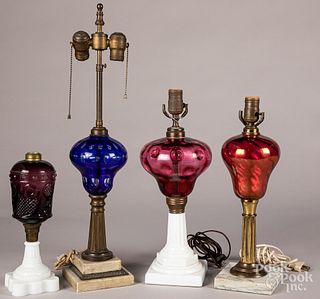 Four colored glass fluid lamps.