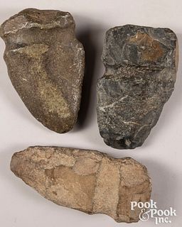 Three massive ancient stone axe heads