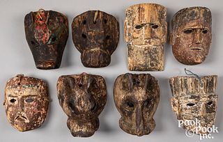 Eight carved and painted Mexican masks