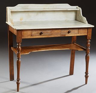 French Provincial Carved Poplar Marble Top Washstand, 19th c., the white marble with an arched back splash with a long shelf, on a base with two friez