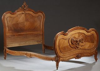 French Louis XV Style Carved Mahogany Three Quarter Sized Bed, c. 1910, the serpentine headboard with a pierced scroll and floral crest, over a crotch
